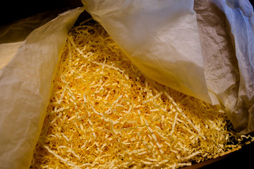 Opened recycled taped cardboard posting and shipping box with shredded Paper Packing Material Delivery, mail service,shipment concept