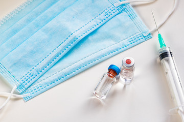 close up on vaccine and medical syringe