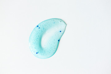 Body scrub smudge on white background, above. Macro texture peeling cosmetic product. Beauty skin care treatment