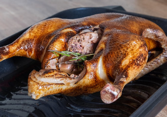 whole roasted or slowly baked duck in roasting pan