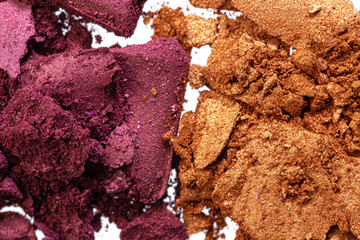 Make up background of mixed colored smashed eyeshadows close up