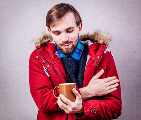 frozen man in red jacket with tea cup