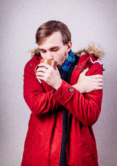 frozen man in red jacket with tea cup