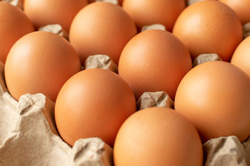 Brown egg in paper packaging. Container for eggs. Recycling. Healthy rustic breakfast