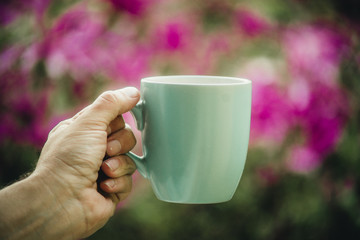 cup in hand on magnolia background