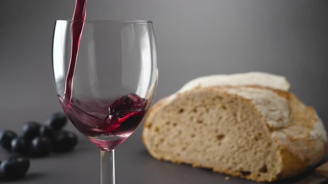 red wine pouring in glass- slow motion