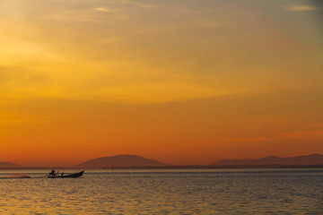 Fototapeta na wymiar Silhouette of fisherman catching fish early in the morning at Laem Ta Chi, Pattani, Thailand