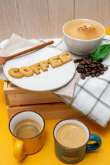 Coffee and cookies over yellow background