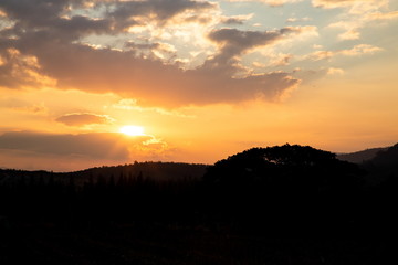 silhouette landscape mountain and sun light beam on twilight sky in the morning .