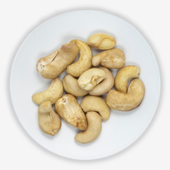 Cashew nuts on a white plate. Isolated background. View from above.