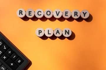 Recovery plan inscription and calculator on office desk. Business and marketing concept. Recovering...
