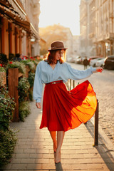 young woman walking on the street in a dress