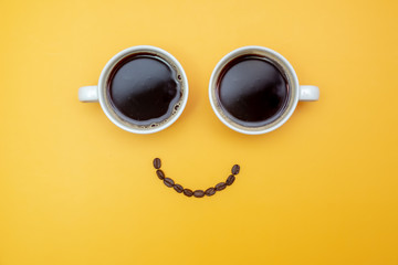 smile coffee (Smiley look made from two cups of coffee and coffee beans)