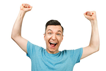 man showing thumbs up and smiling, rejoices in victory, in blue shirt, isolated
