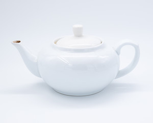 White teapot on white background, over light