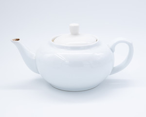 White teapot on white background, over light