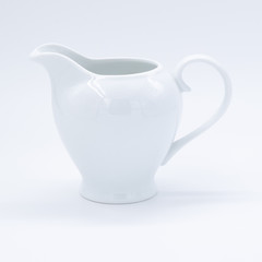 White teapot on white background, over light