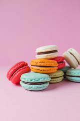 Beautiful colourful desserts. french macaroons on a pink background