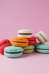 Beautiful colourful desserts. french macaroons on a pink background