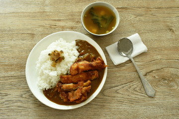 deep fried chicken dressing with Japanese curry on rice topping slice pickled cabbage