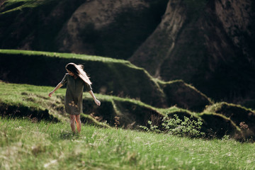 beautiful emotional girl on green saturated hills