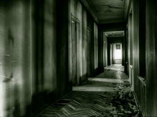 Fototapeta na wymiar Dark long corridor in an abandoned building