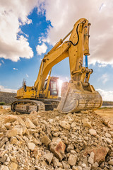 Excavator in a quarry extracting stone