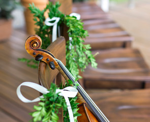 Violin on a wooden chair. Wedding decorations. Art. Live music.