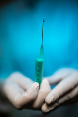 Nurse holding a Syringe and a vaccine container.