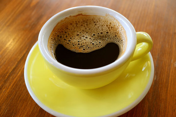 Cup of smiling shape black coffee on a wooden table	
