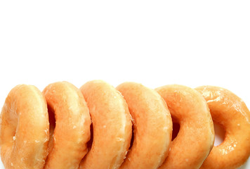 Row of Mouthwatering Sugar-glazed Donuts Isolated on White Background