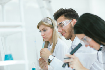 close up.a group of young scientists conduct experiments in the