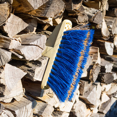 old broom at s stack of wood