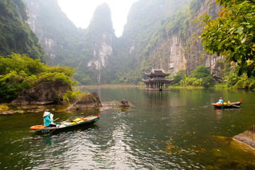 Ninh Binh boat ride through mountains Vietnam 