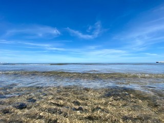 The cleanest sea on a city beach in Valencia, Spain. Clear water and blue sky. Сoastline