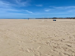 Spain's deserted beaches during siesta and quarantine. Blue sky and bright sun and white sand. Valencia, Spain
