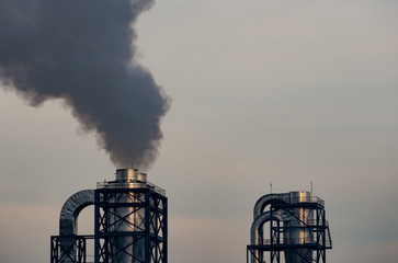 Air pollution from factory. Black smoke from chimney of industrial pipe. Global warming problem...