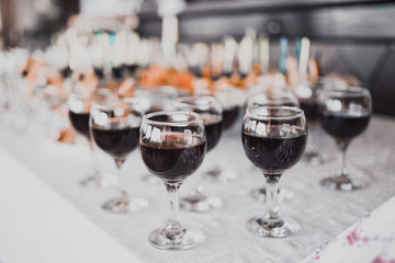 many glasses of wine. catering services in restaurant outdoor on wedding ceremony. Food and glass of champagne. restaurant