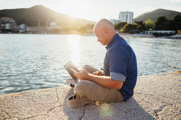 freelancer browsing laptop on beach