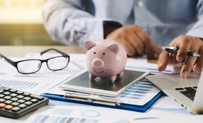 Financial Report- Business Accounting money stack Concept Business Man Using Calculator graph discussion and analysis data charts and graphs