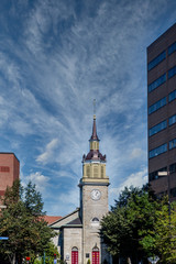Fototapeta na wymiar An old Grey Stone Church Steeple and Clock Tower in Portland, Maine
