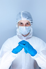 a man in a protective suit, gloves and face mask. The concept of health care.