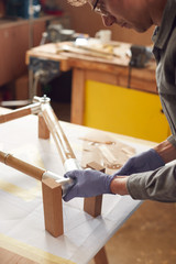 Close Up Of Male Craftsman In Workshop Assembling Hand Built Sustainable Bamboo Bicycle Frame