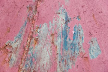 Rusty pink metal wall background with streaks of rust, texture background