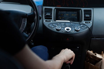 Man driving. The driver holds the steering wheel with his hand.
