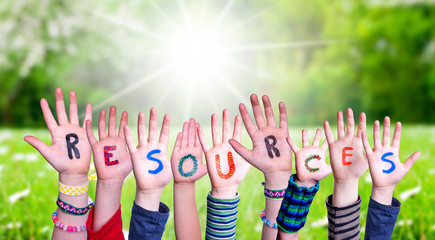 Children Hands Building Colorful Word Resources. Green Grass Meadow As Background