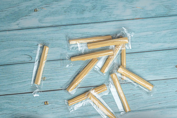 Thai Sweet Sugar Candy Look Like Stick Wood on old Ceramic Dish with Blue Wooden Background, Flat Lay top view angle