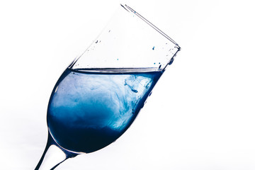 a stream of water pours into the glass. water splashes