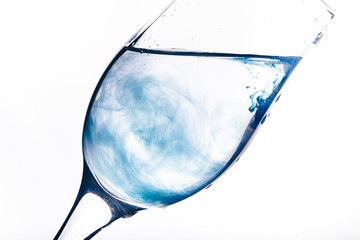 a stream of water pours into the glass. water splashes
