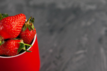 Ripe red strawberries. Bowl filled with juicy fresh ripe red strawberries. strawberries on a grey concrete table. Fresh strawberries photo. Сoncept healthy food
